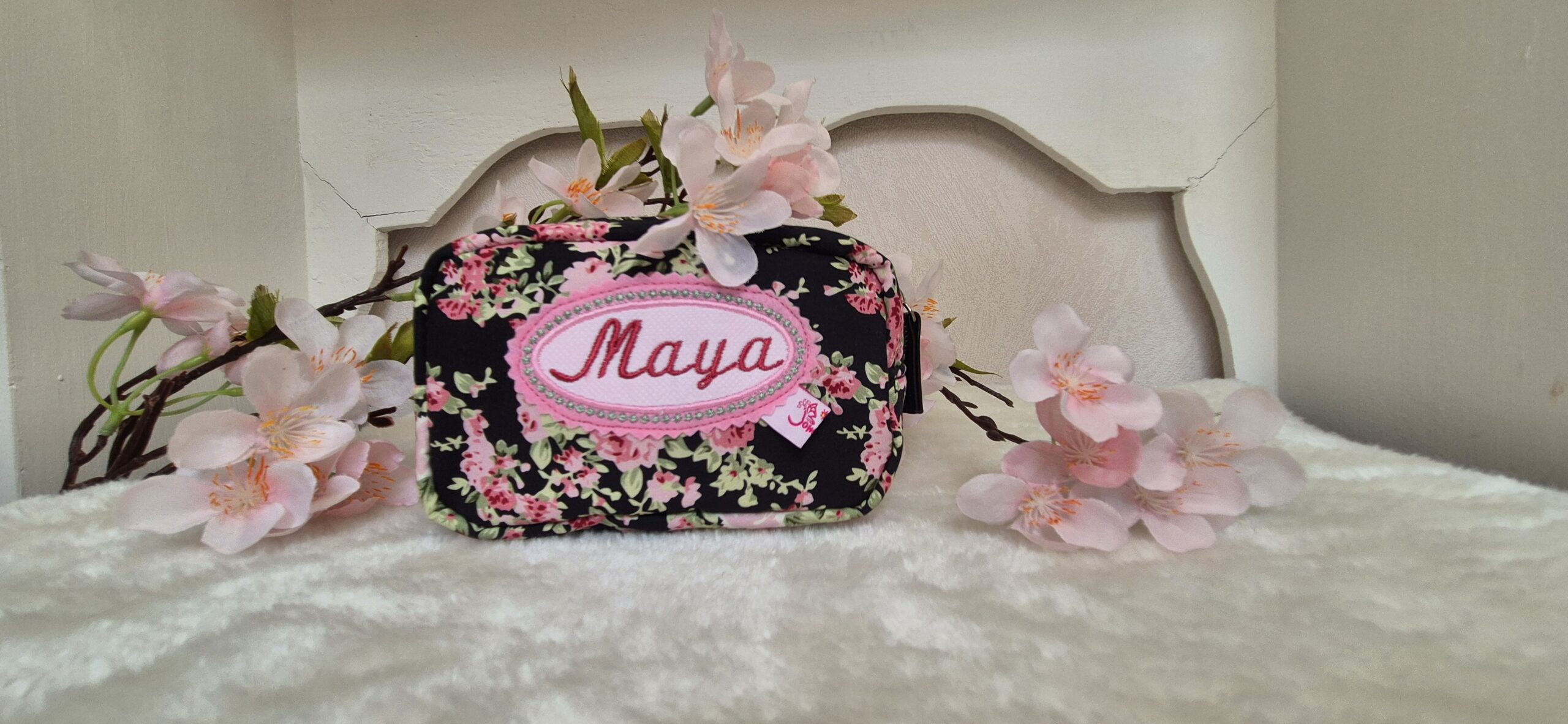 Personalisiertes Kosmetiktäschchen mit Namensstickerei als Geburtstagsgeschenk für eine junge Dame.